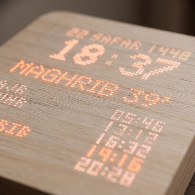 Close-up of the maple veneer grain and matte teak-tinted finish